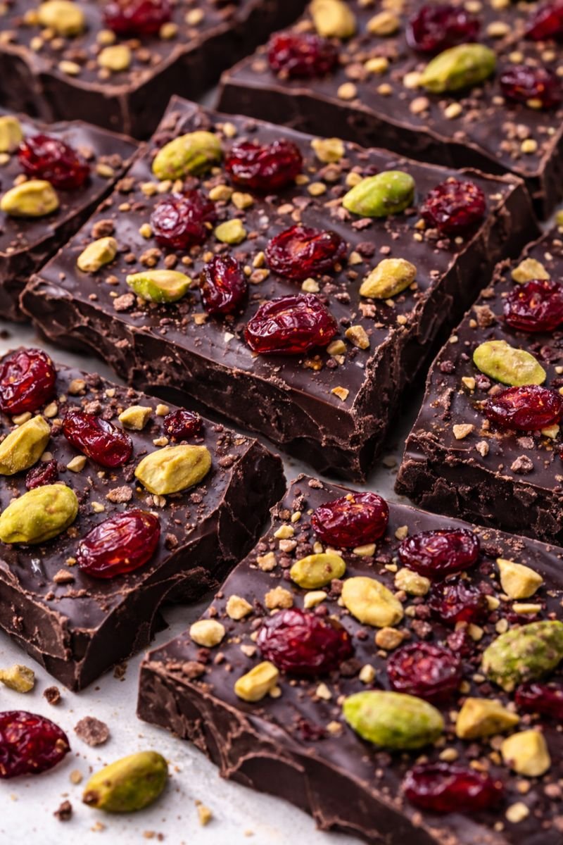 sweet & salty dark bark with pistachios and cranberries close up sweet & salty dark bark with pistachios and cranberries close up